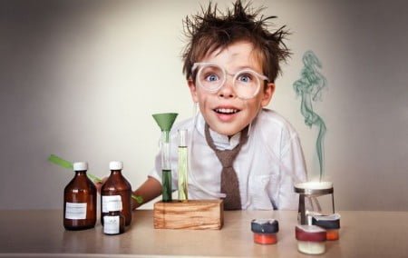 Crazy scientist. Young boy performing experiments